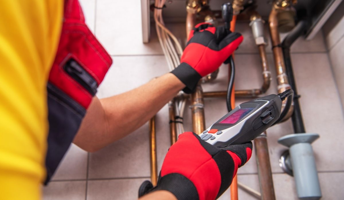 person checking for water pipe damage