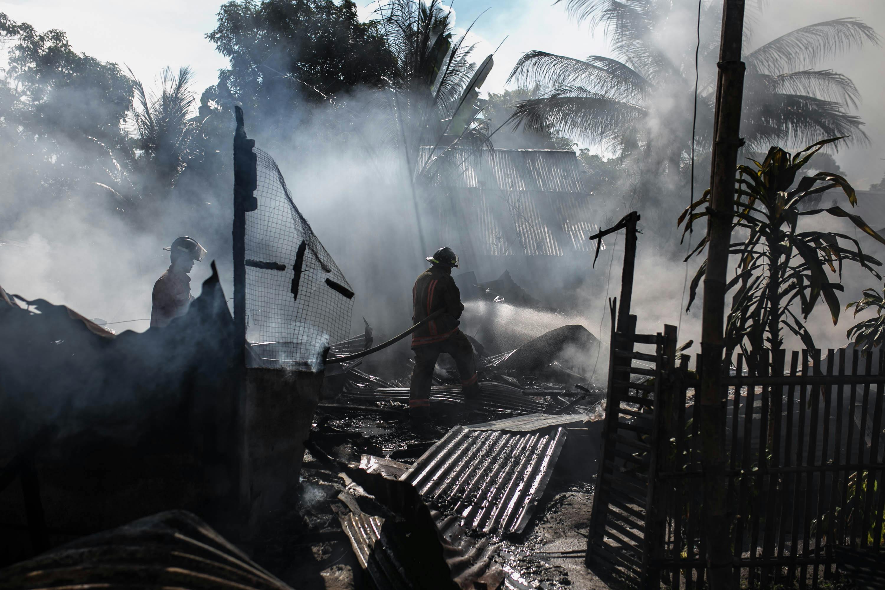 firefighter looking at damage to property