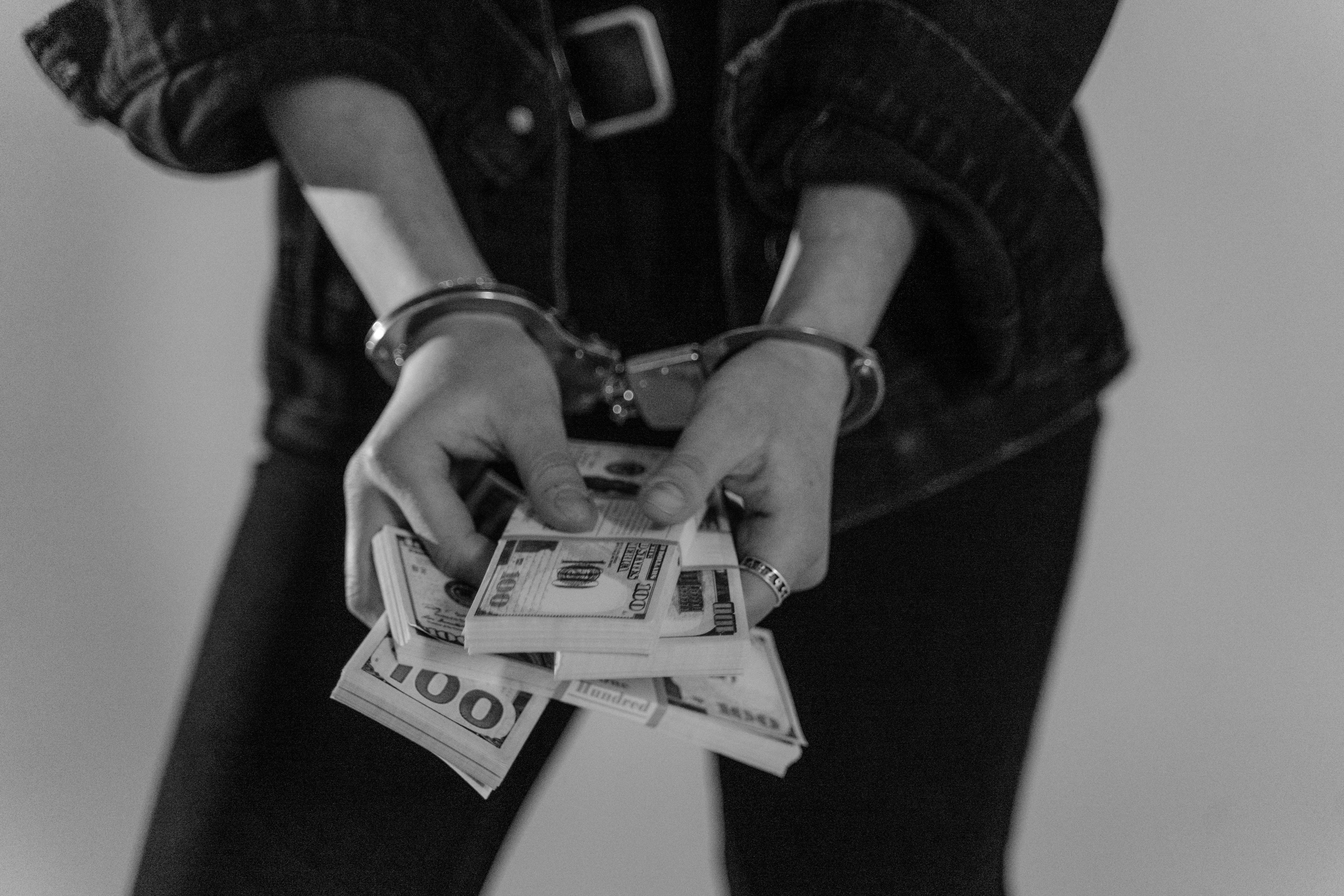 person counting money as a robbery